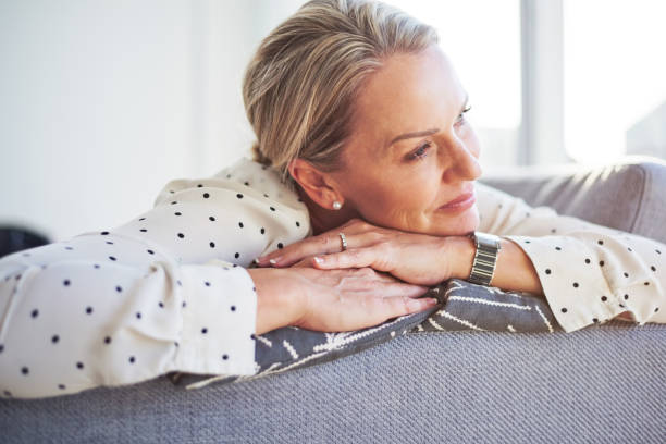 Shot of a happy mature woman relaxing on the sofa at home
